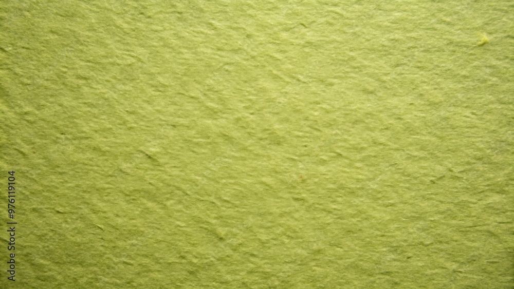 Fototapeta premium Closeup of the texture of old green paper, showing the dense structure of light olive cardboard