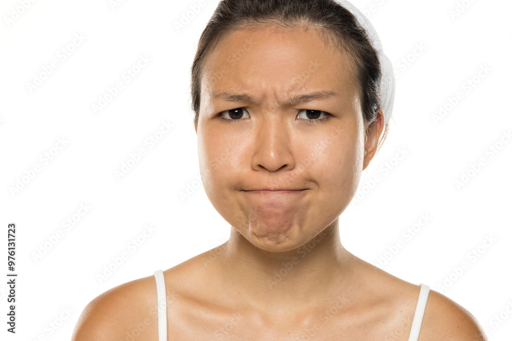 Portrait of a beautiful young angry Asian woman posing on white studio background. Portrait of a beautiful young angry Asian woman posing on white studio background.