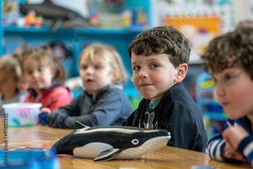 A group of children learning about whales in a classroom, their faces filled with fascination as they discover the wonders of the ocean