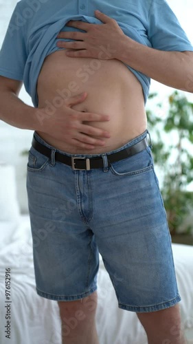 Abdominal massage, tummy tuck, fat belly, man doing self-massage, health problems concept