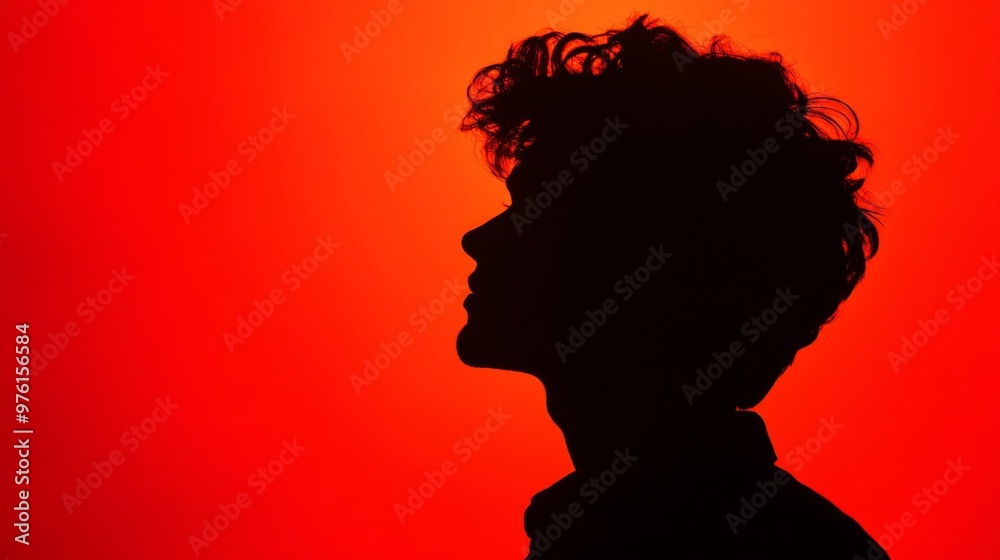 Young man profile silhouette posing on red background Young man profile silhouette posing on red background