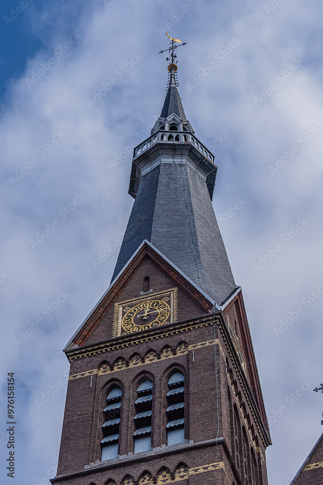 Fototapeta premium View of Neo-Gothic Post Horn Church (Posthoornkerk, 1863) with three slender towers on bustling Haarlemmerstraat - one of most important surviving XIX century churches. Amsterdam, the Netherlands.