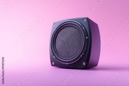 A black speaker on a pink background, designed for audio playback. photo