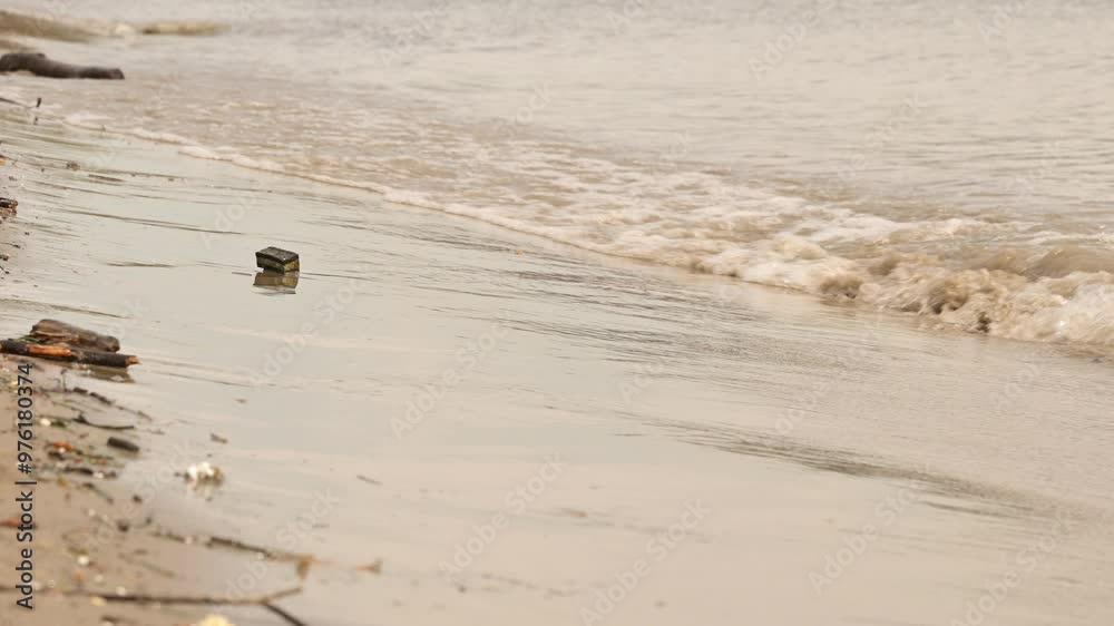Danube river wave splashing on the sandy shore Danube river wave splashing on the sandy shore