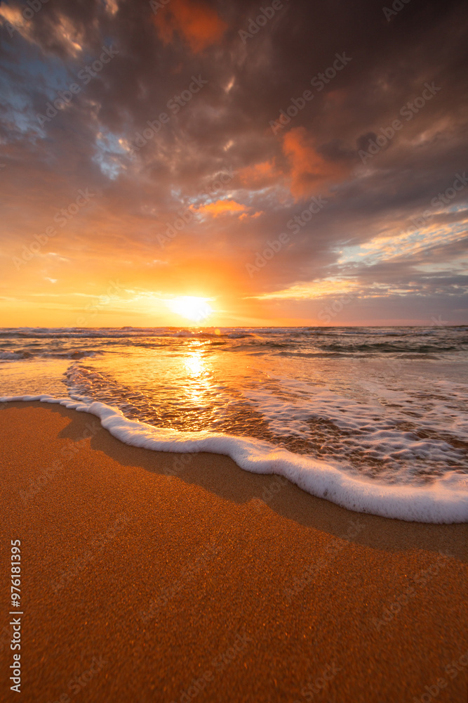Scenic sunrise over sea splashing waves on the beach, exotic ocean shore sunset vertical view Scenic sunrise over sea splashing waves on the beach, exotic ocean shore sunset vertical view