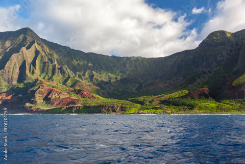 Nā Pali Coastline with Lush Green Cliffs and Blue Ocean in Kauai, Hawaii photo