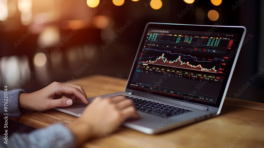 A male trader analyzing stock market data on a laptop in a cozy setting. A male trader analyzing stock market data on a laptop in a cozy setting.