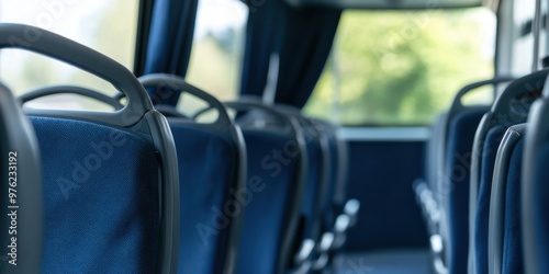 An image of empty blue seats inside a bus, with natural light filtering through the windows, symbolizing solitude and a moment of reflective peace before the journey begins. photo