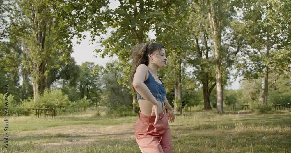 Gorgeous girl performing modern dance in an urban park with lush greenery, expressing movement and freedom in a natural setting. Gorgeous girl performing modern dance in an urban park with lush greenery, expressing movement and freedom in a natural setting.