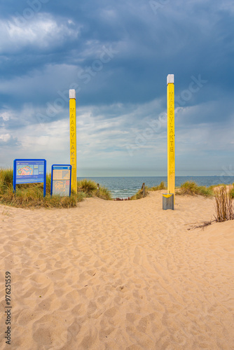 A entry way to the beach with yellow poles on the 2nd Maasvlakte in Rotterdam