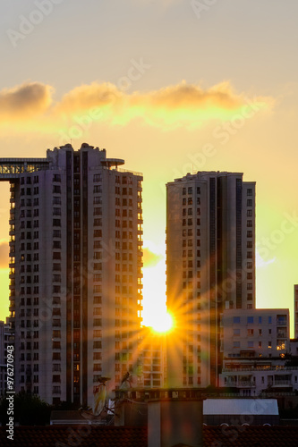 Istanbul-Turkey. 09 15 2024. A cluster of modern high-rise apartment buildings is seen during sunset, with warm light reflecting off the windows in an urban neighborhood.
 photo