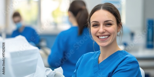 A female medical staff member, dressed in blue scrubs, is seen working diligently in a clinical setting, surrounded by medical equipment and other healthcare professionals.