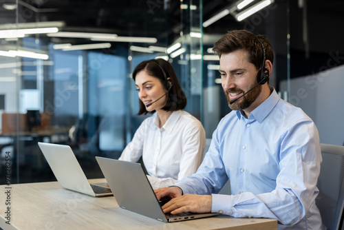 Customer service representatives engaged in professional work using headsets and laptops. Team collaboration and effective communication emphasized in a modern office environment