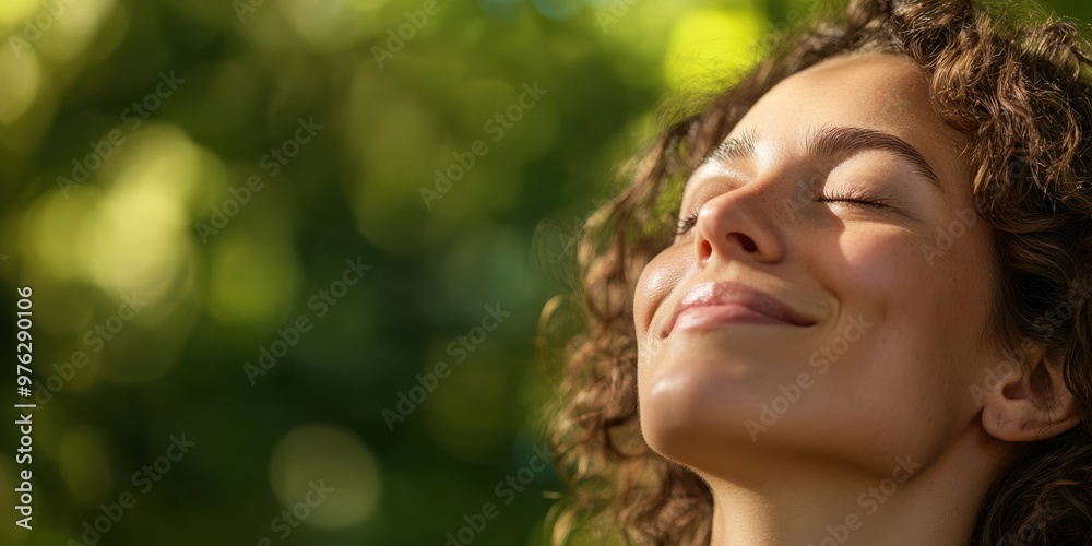 A close-up of a woman with curly hair looking upwards, set against a blurred green bokeh background, capturing a moment of contemplation and connection with nature. A close-up of a woman with curly hair looking upwards, set against a blurred green bokeh background, capturing a moment of contemplation and connection with nature.