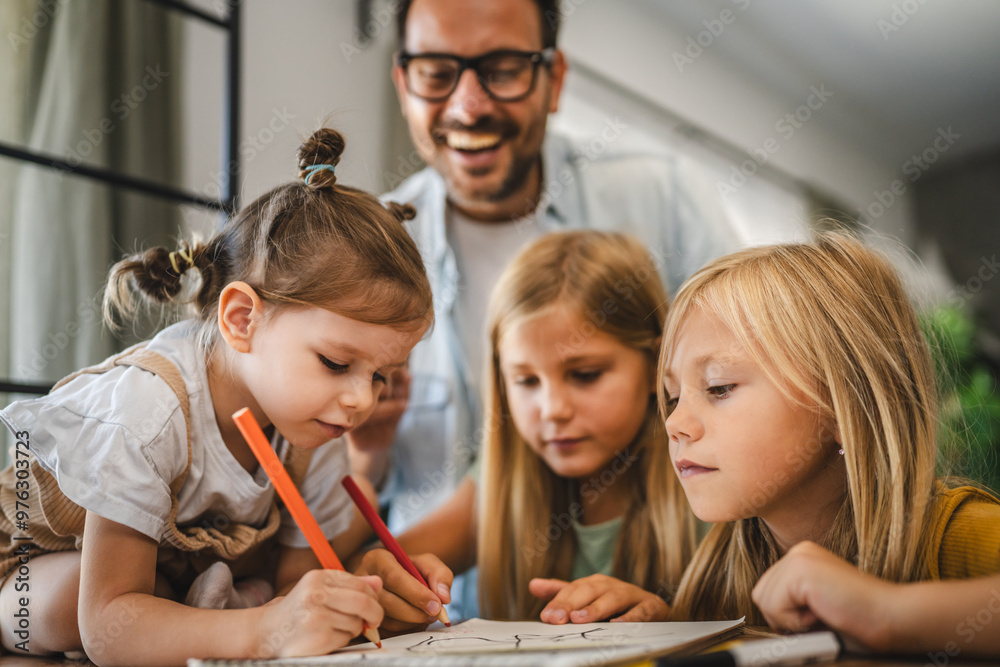 three young daughters draw and color in the notebook at home three young daughters draw and color in the notebook at home