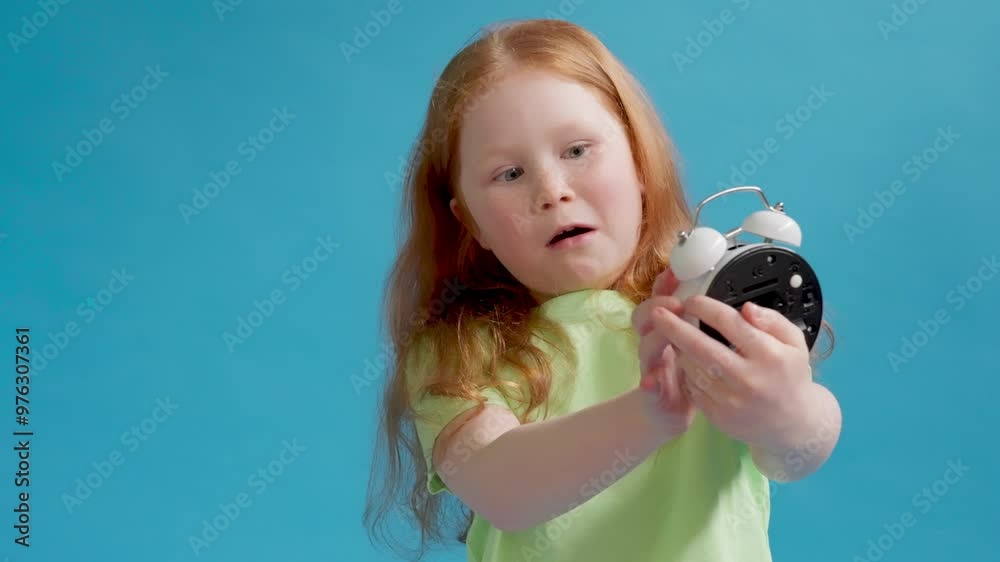 Curious Child Holding White Alarm Clock in Vibrant Studio Setting Curious Child Holding White Alarm Clock in Vibrant Studio Setting