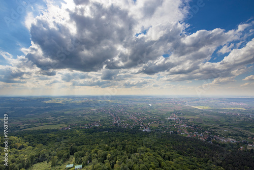 A city with a lot of trees and a cloudy sky