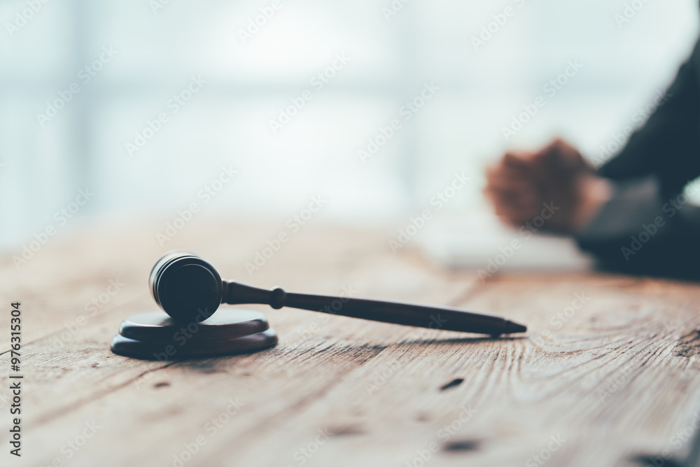 The Gavel of Justice: A wooden gavel rests on a desk, symbolizing the finality of a decision, the weight of authority, and the power of the law. This evocative image captures the essence of justice an The Gavel of Justice: A wooden gavel rests on a desk, symbolizing the finality of a decision, the weight of authority, and the power of the law. This evocative image captures the essence of justice an