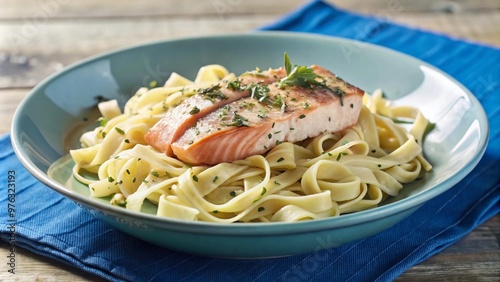 Delicious Herb-Seasoned Salmon Fillet on a Bowl of Cooked Pasta, Appetizing Culinary Presentation, Gourmet Dining Experience.