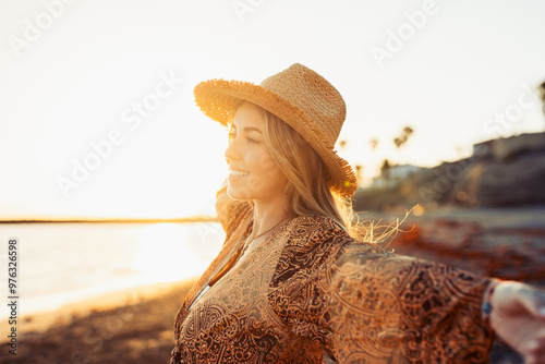 Portrait of one young woman at the beach with openened arms enjoying free time and freedom outdoors. Having fun relaxing and living happy moments.. #976326598