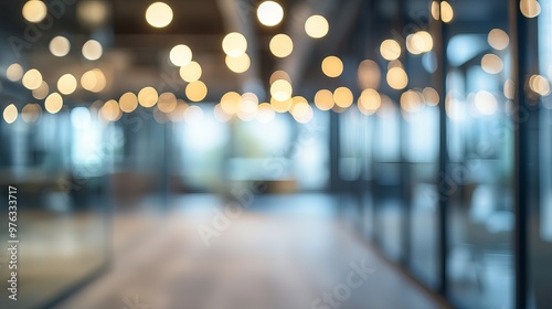 Blurred image of an empty open office space with abstract light bokeh representing the interior background