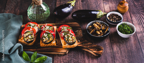 Wallpaper Mural Fried toasts with grilled eggplant, tomatoes and cheese on a board on the table web banner Torontodigital.ca