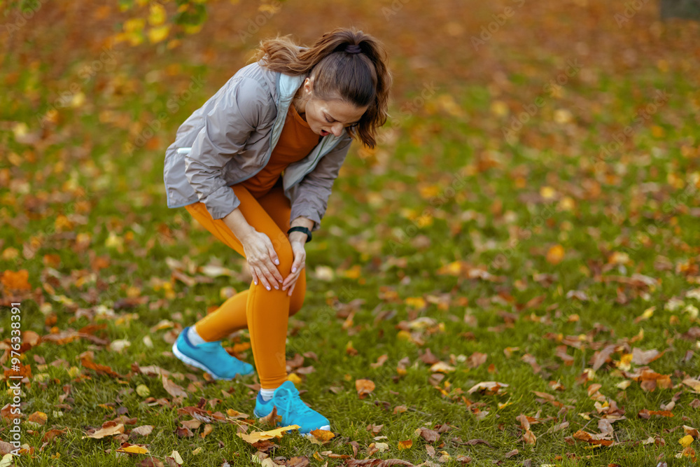 sad woman in fitness clothes in park sad woman in fitness clothes in park
