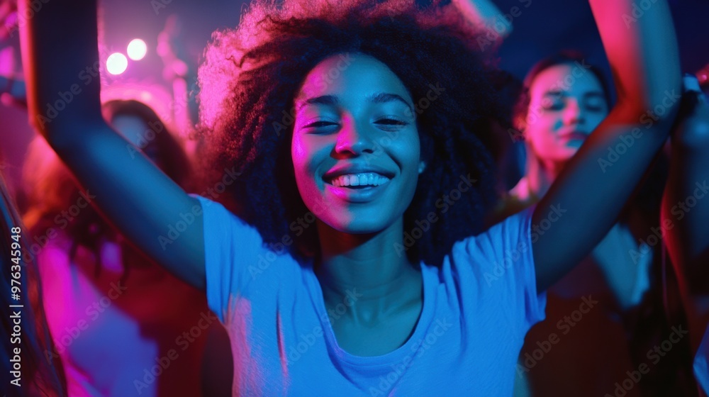 Young woman dancing joyfully at a vibrant party in colorful lights Young woman dancing joyfully at a vibrant party in colorful lights