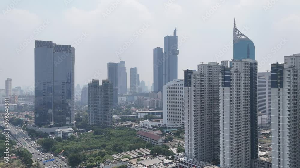 Aerial view of towering skyscrapers in the city of Jakarta. The city of Jakarta is the capital city of Indonesia which is located on the island of Java. Aerial view of towering skyscrapers in the city of Jakarta. The city of Jakarta is the capital city of Indonesia which is located on the island of Java.