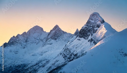 Serene snow-capped peaks at sunrise with golden light touching the mountain tops