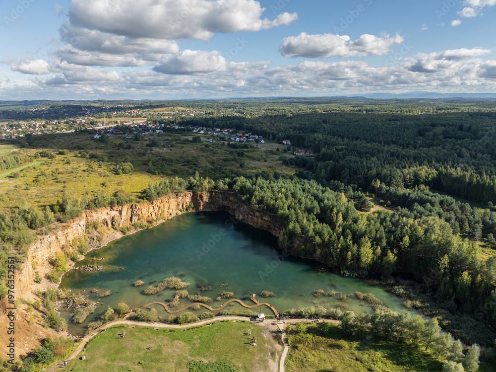 Aerial drone photo of Quarry turquiose lake colour, open pit mining in Park Grodek, Jaworzno. Poland. Turquiose Water and Wooden Bridge on lake. Polish Maldives Park Grodek in Jaworzno from drone. Aerial drone photo of Quarry turquiose lake colour, open pit mining in Park Grodek, Jaworzno. Poland. Turquiose Water and Wooden Bridge on lake. Polish Maldives Park Grodek in Jaworzno from drone.
