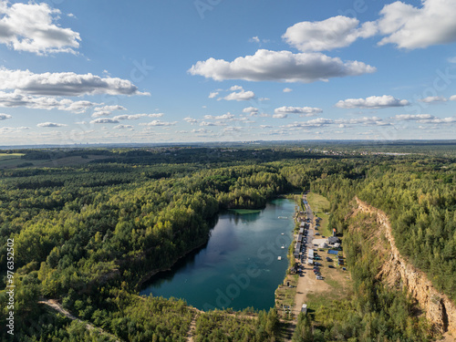 Aerial drone photo of Quarry turquiose lake colour, open pit mining in Park Grodek, Jaworzno. Poland. Turquiose Water and Wooden Bridge on lake. Polish Maldives Park Grodek in Jaworzno from drone.