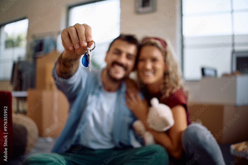 Close up of couple with keys of their new home. Close up of couple with keys of their new home.