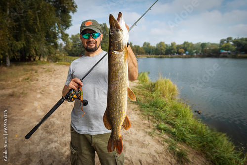 Fisherman and trophy Pike. Fishing background.	
