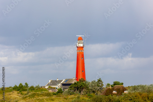 The red lighthouse north tower (Noordertoren) on the dune, Schiermonnikoog is a municipality and national park in the Northern Netherlands, One of the West Frisian Islands on the edge of the North Sea photo