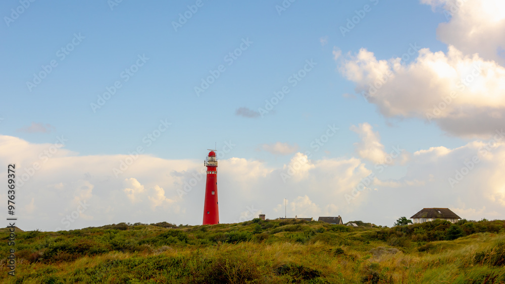 The red lighthouse north tower (Noordertoren) on the dune, Schiermonnikoog is a municipality and national park in the Northern Netherlands, One of the West Frisian Islands on the edge of the North Sea The red lighthouse north tower (Noordertoren) on the dune, Schiermonnikoog is a municipality and national park in the Northern Netherlands, One of the West Frisian Islands on the edge of the North Sea