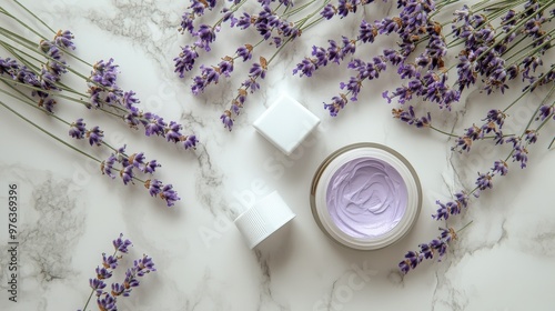 Lavender flowers paired with skincare products on a marble surface during day...
