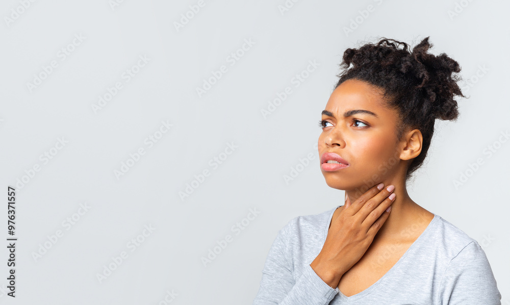 Upset afro woman having pain in her throat, touching neck, panorama with copy space Upset afro woman having pain in her throat, touching neck, panorama with copy space