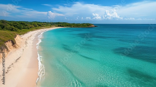 Tranquil Caribbean coastline with clear turquoise waters and sandy shoreline ...