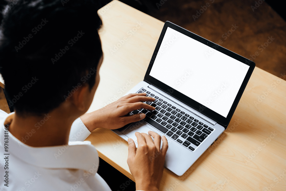 Business person or office worker using laptop computer while sitting at desk. uds Business person or office worker using laptop computer while sitting at desk. uds