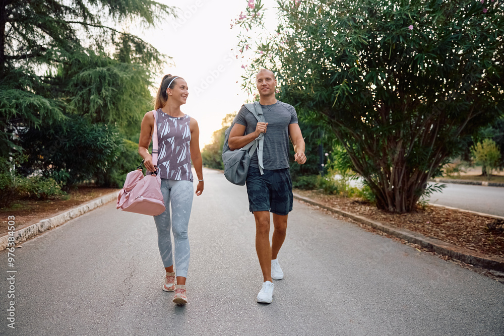 Happy couple of athletes going on sports training in park. Happy couple of athletes going on sports training in park.