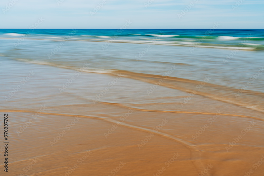 Soft focus seashore with gentle waves and blurred reflections. Soft focus seashore with gentle waves and blurred reflections.