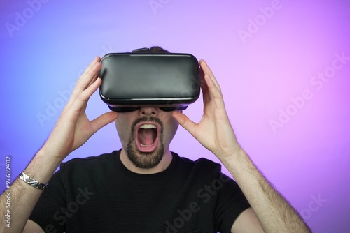 Surprised man using virtual reality device