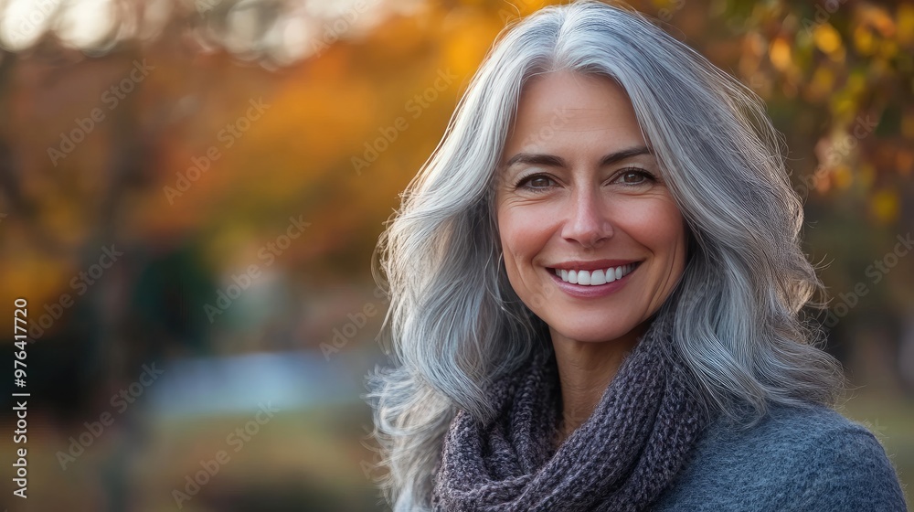 A radiant middle-aged woman with silver-gray hair, smiling warmly in an outdoor setting, showcasing beauty at any age A radiant middle-aged woman with silver-gray hair, smiling warmly in an outdoor setting, showcasing beauty at any age