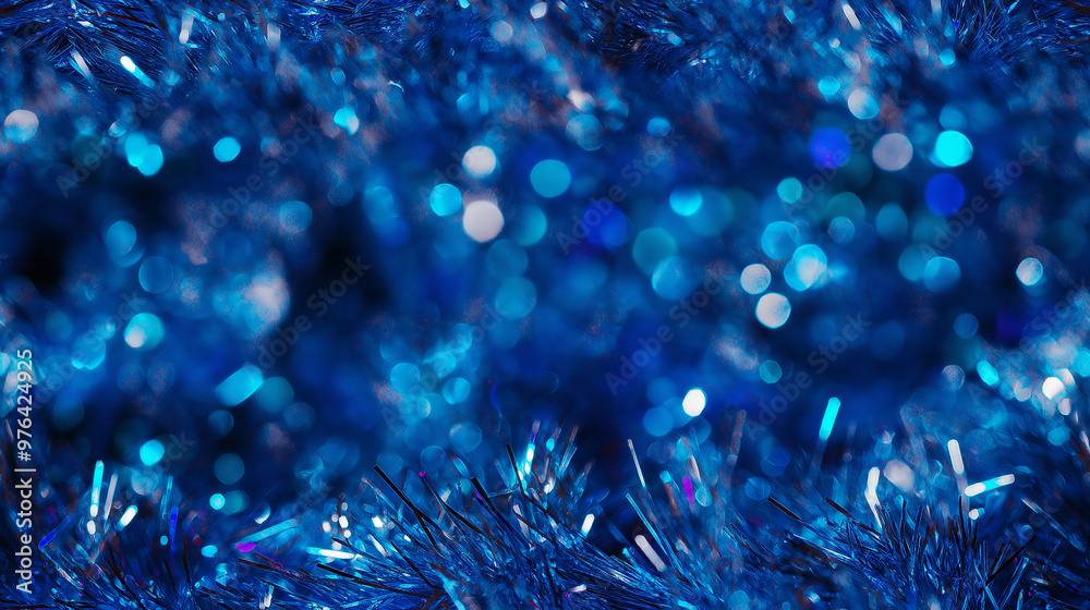 Fototapeta premium shimmering tinsel garland texture with a blend of metallic deep blue, turquoise and silver strands