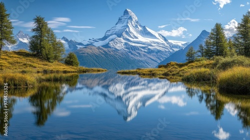 Majestic snow-capped mountain range reflected in the still mirror-like surface of a tranquil alpine lake