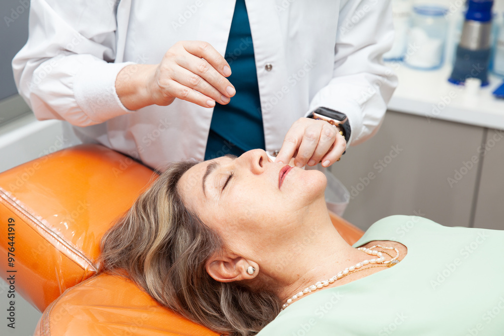 Fototapeta premium Senior female patient at the dermatologist for a routine checkup. Dermatology concept. Medicine concept. Senior medicine concept.