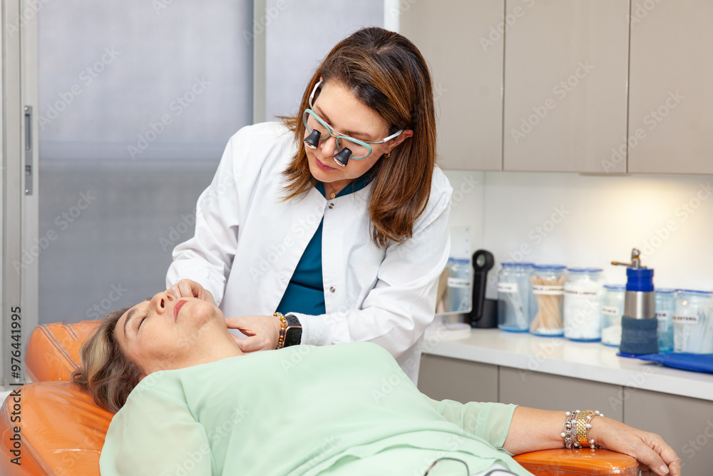 Dermatologist making a routine checkup on a senior famale patient using a binocular loupe. Dermatologist making a routine checkup on a senior famale patient using a binocular loupe.