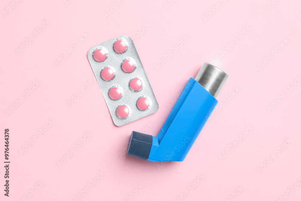 Asthma inhaler and pills on pink background, flat lay Asthma inhaler and pills on pink background, flat lay