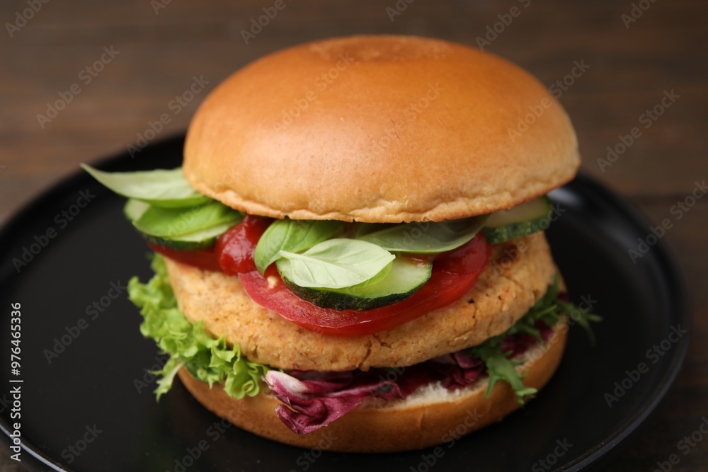 Delicious vegan burger with chickpea cutlet on wooden table, closeup Delicious vegan burger with chickpea cutlet on wooden table, closeup